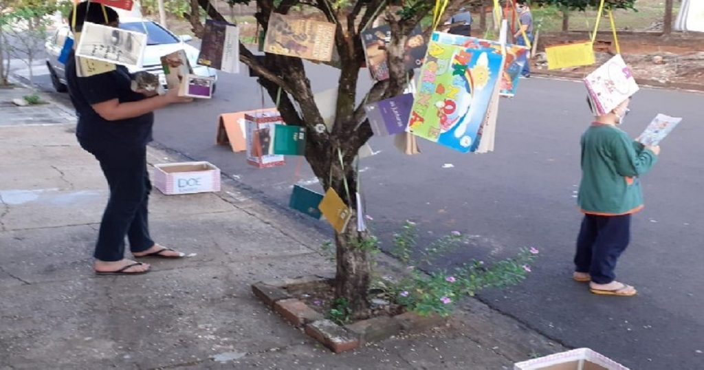 Professora pendura livros em árvore na frente de sua casa para doação
